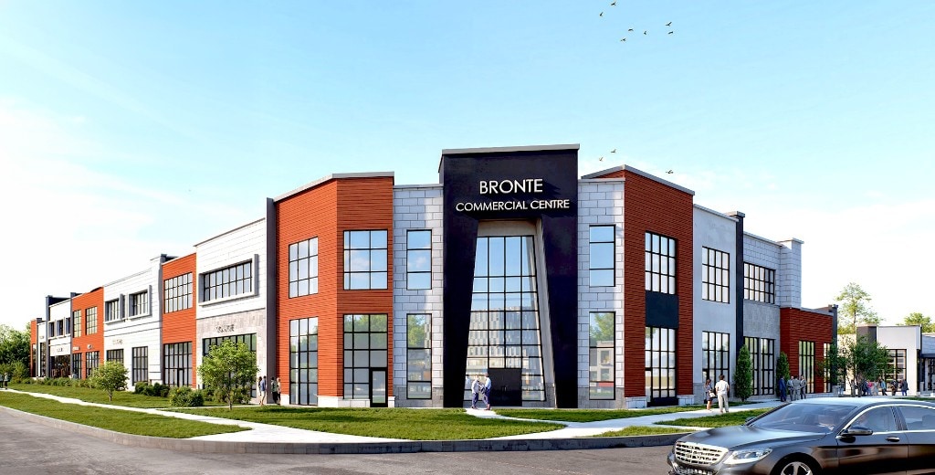 Bronte Commercial Centre, corner view with black entrance tower, terracotta and light stone, glass frontage, lawn and walk